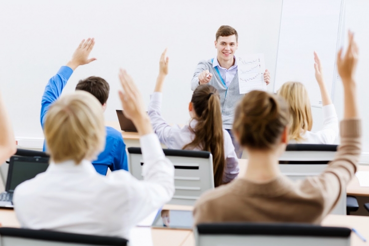 People raising hands getting benefits of employee training software